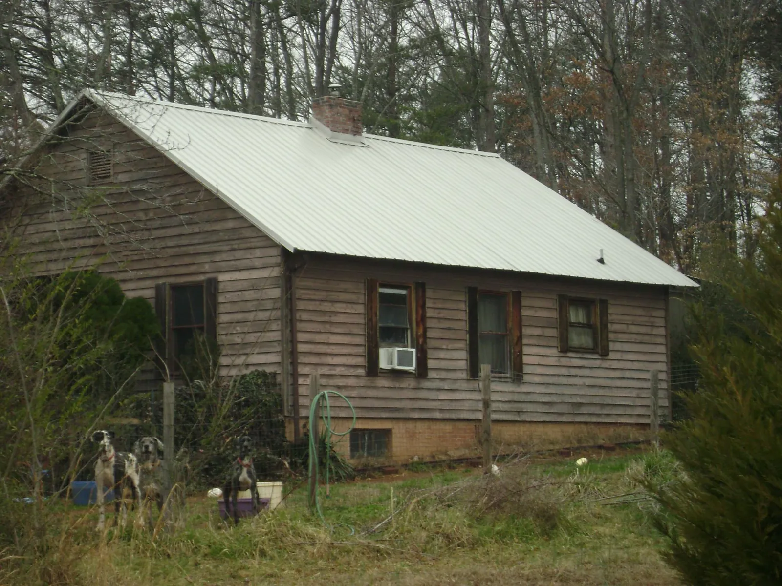 White metal roof on an old wood sided farmhouse, from a Metal Roof Installation job in Glendora
